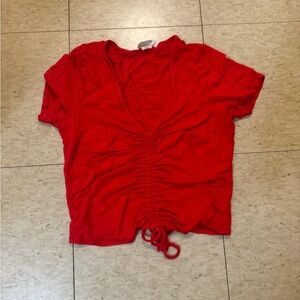 - Bright red crop top from Marshall’s Haze brand